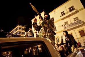 BENGHAZI, LIBYA - FEBRUARY 18: Members of a revolutionary militia group supporting the General National Congress, stand alert in the streets of Benghazi, the second largest city in Libya, on February 18, 2014. A Libyan militia set a five-hour ultimatum for the General National Congress (interim parliament) to hand over power, threatening to "target" lawmakers and bring them to justice if they failed to heed the ultimatum. (Photo by Mohamed Elshaiky/Anadolu Agency/Getty Images)